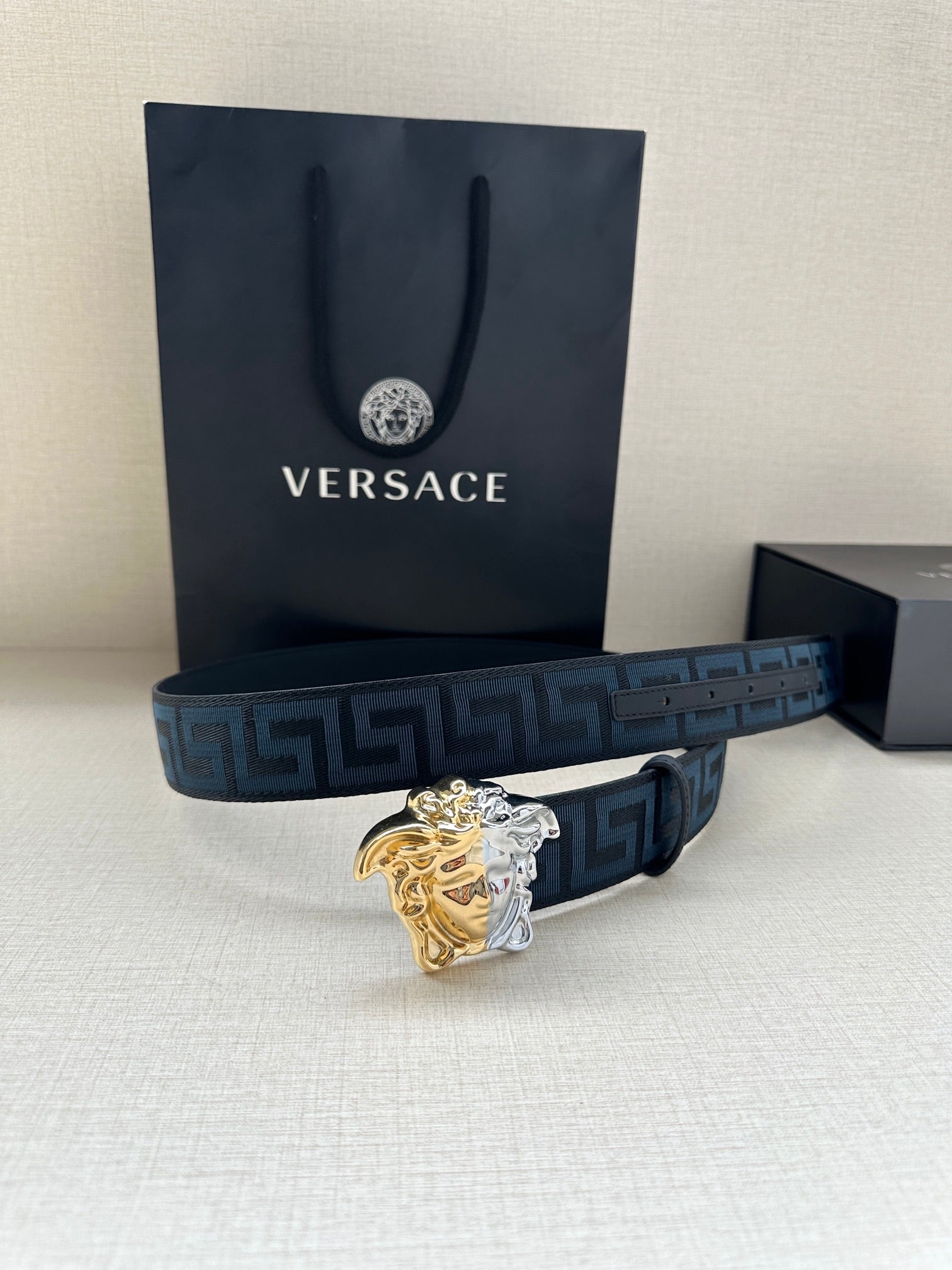 Dark blue Greca belt with gold-silver Medusa buckle and branded gift bag