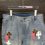 Light blue denim shorts, front view, with colorful cross patches on legs