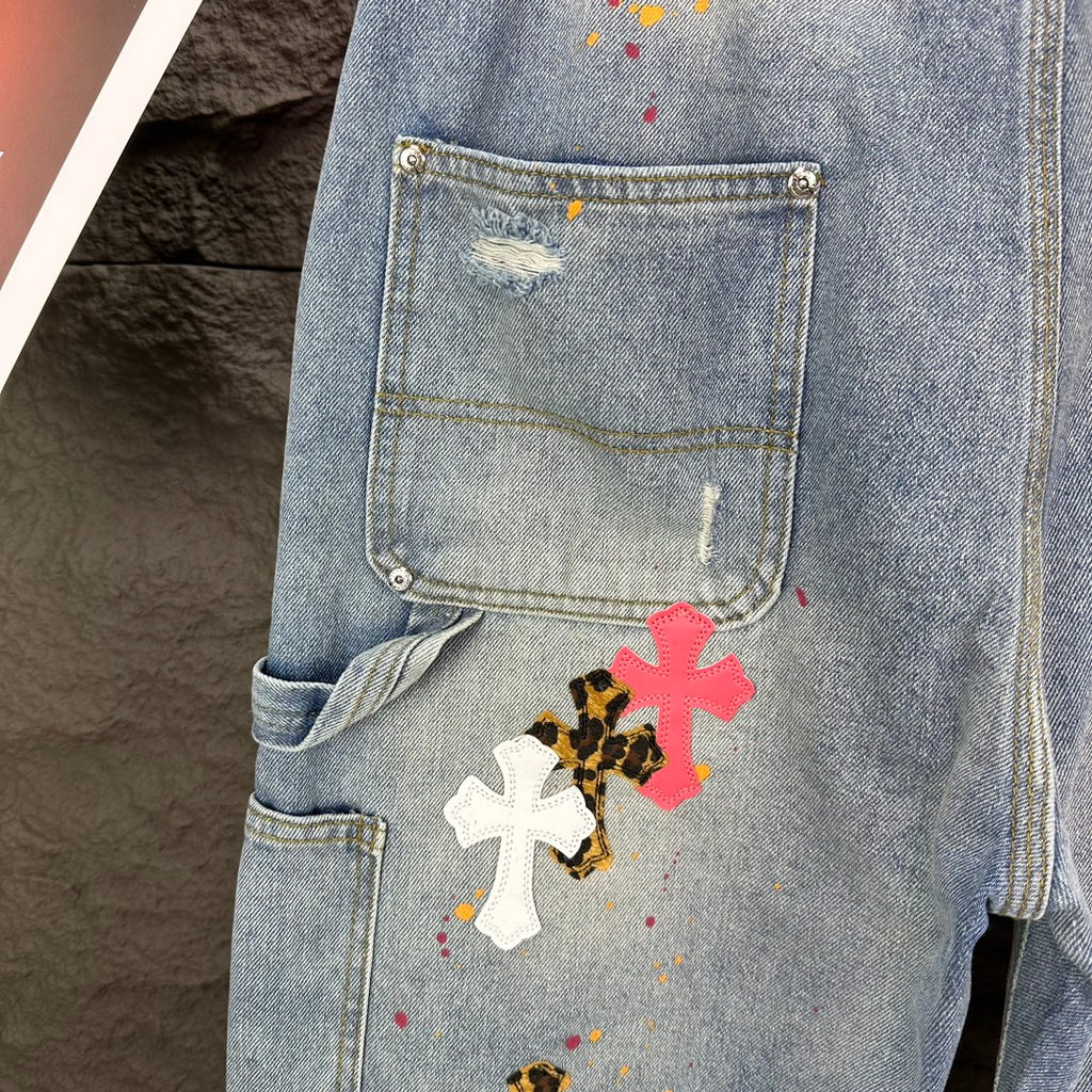 Denim shorts pocket detail with colorful cross graphic on thigh