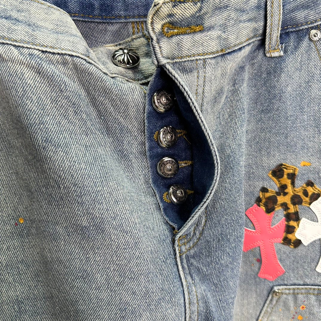 Denim shorts waistband detail with metal button fly and cross patch