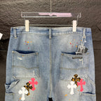 Light blue denim shorts rear view with two patch pockets and cross graphics