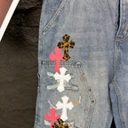 Light blue denim shorts close-up of cross patches on front pocket area