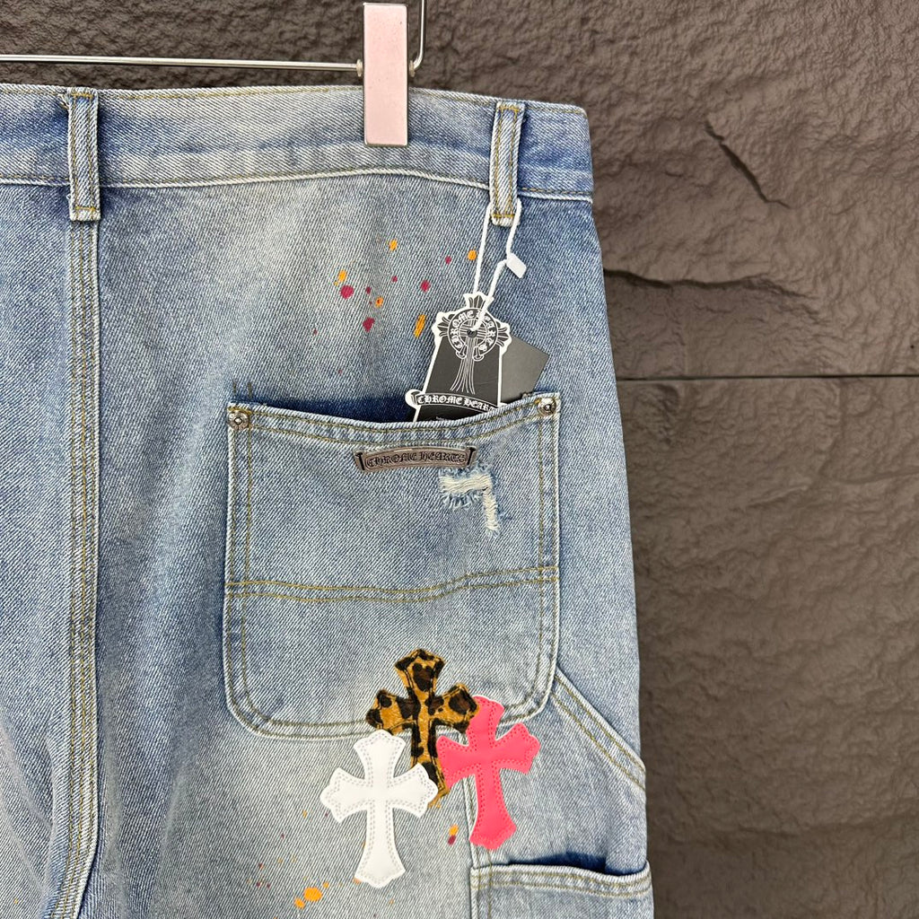 Light blue denim shorts with hanging tag and cross patch on front pocket