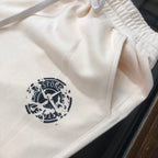Stone Island cream shorts with logo print on the thigh and elastic waistband