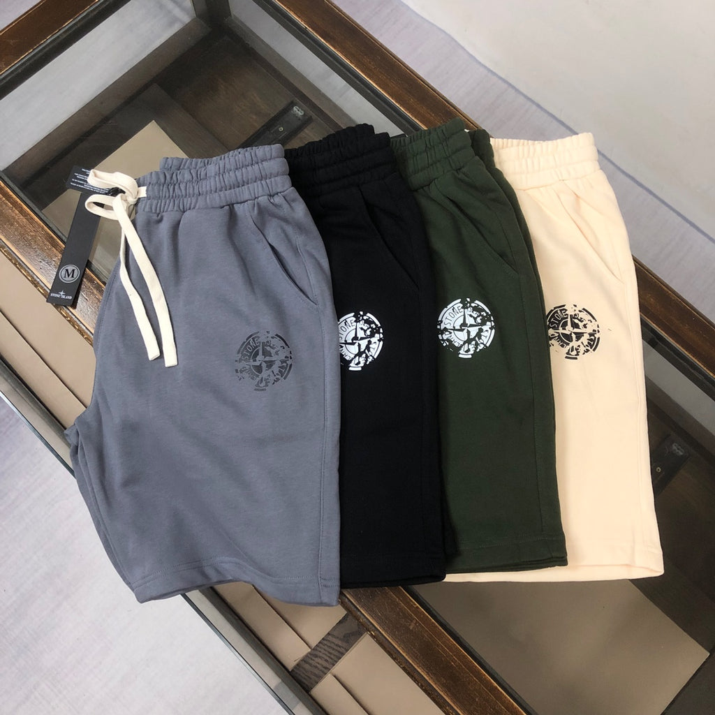 Four Stone Island drawstring shorts in gray, black, green, and cream with logos