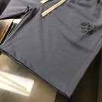 Drawstring shorts hem with small logo patch, dark gray