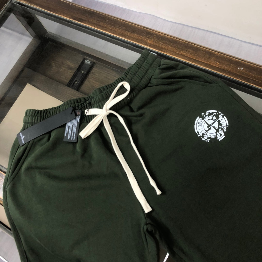 Stone Island green drawstring shorts with elastic waistband and white logo emblem