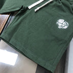 Stone Island dark green shorts with drawstring cord and white logo emblem