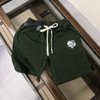 Stone Island green drawstring shorts with elastic waistband and logo patch