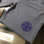 Stone Island dark gray shorts with blue embroidered logo on the leg