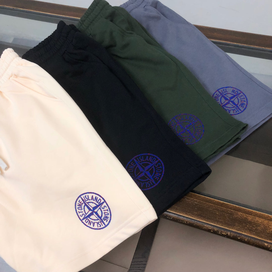 Drawstring shorts assortment: cream, black, dark green, and light blue with logo emblems