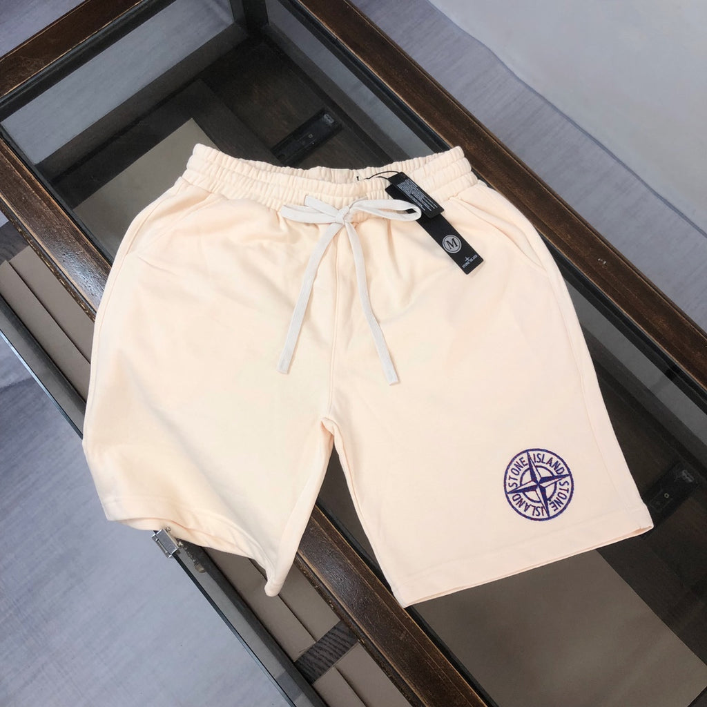 Stone Island logo drawstring shorts, light cream with blue patch on the leg