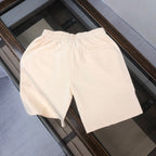 Stone Island drawstring shorts, light cream with elastic waistband, no visible logo