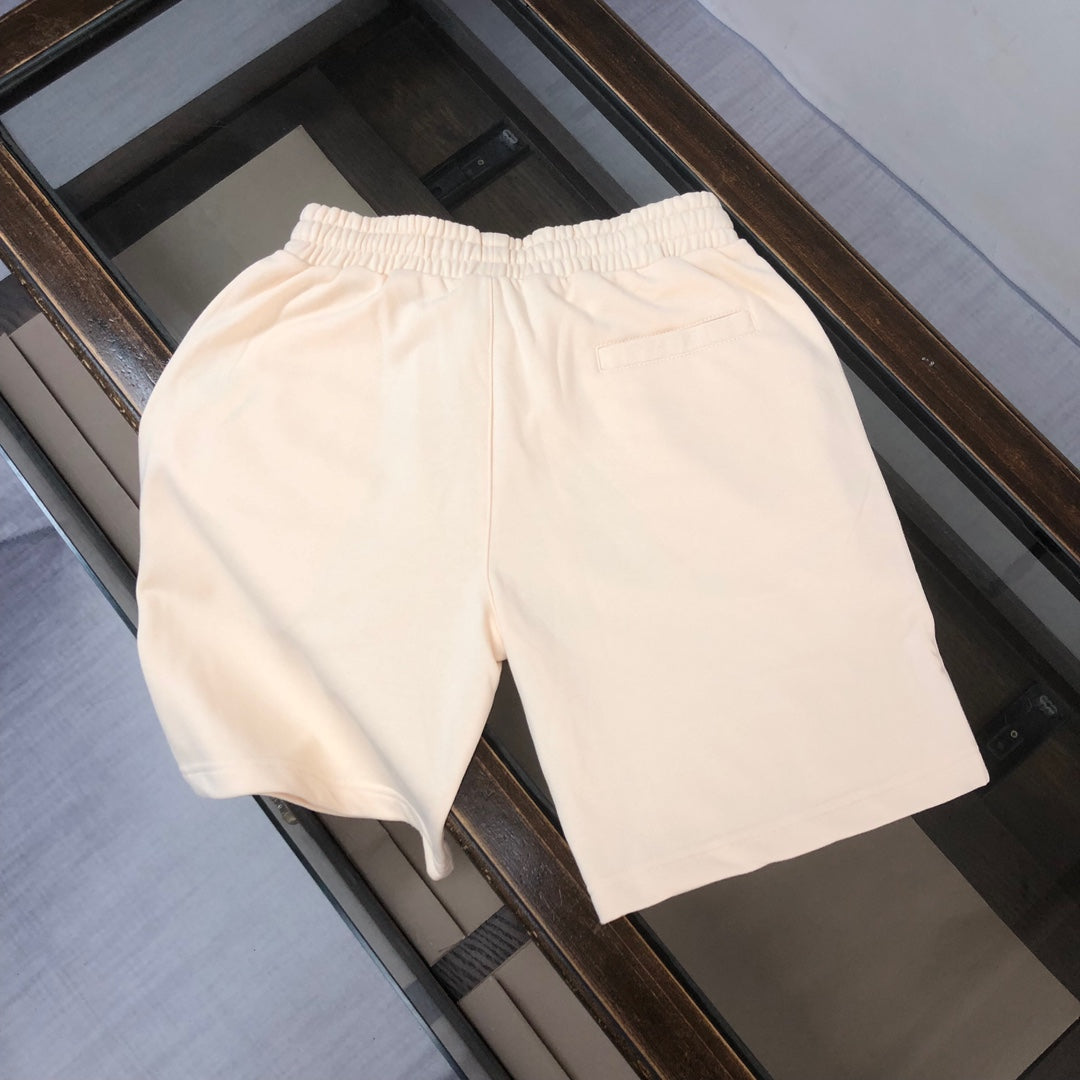 Stone Island drawstring shorts, light cream with elastic waistband, no visible logo