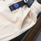Stone Island drawstring shorts waistband and seam detail, light cream