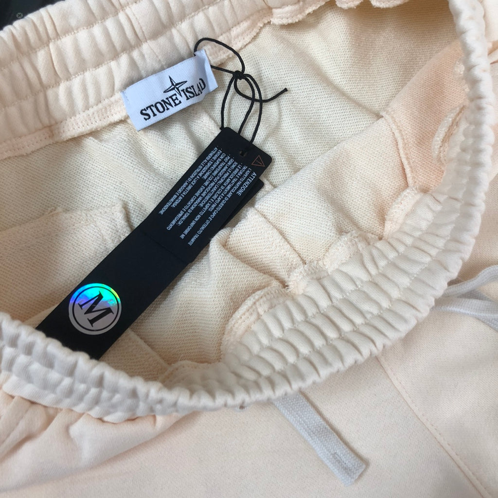 Stone Island shorts inside view with elastic waistband and size tags, light cream