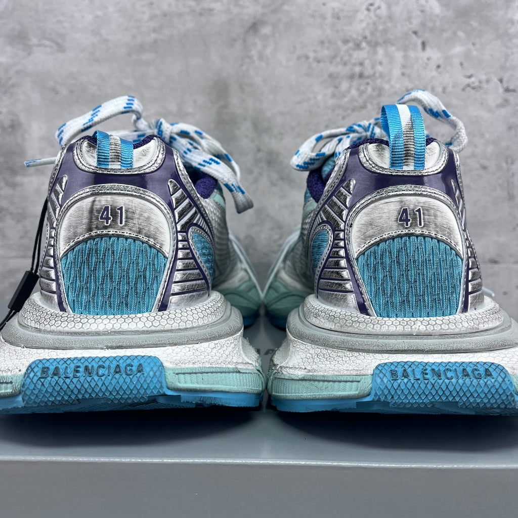 Balenciaga running shoes heel view with BALENCIAGA logo on light blue midsoles.