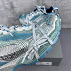 Balenciaga running shoes close-up with aqua and silver textures and white laces.