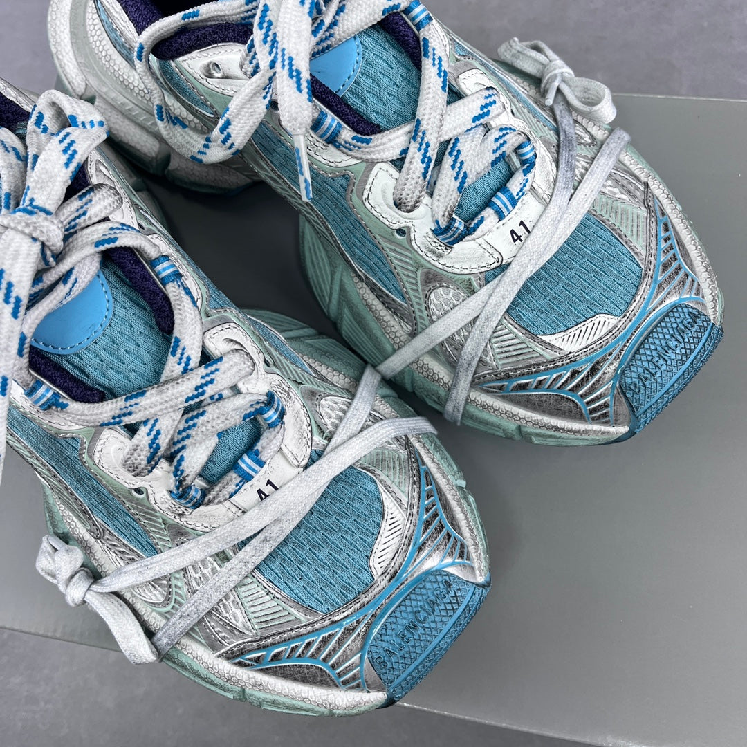 Balenciaga running shoes with white laces and aqua mesh uppers, angled pair view.