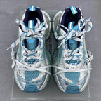 Balenciaga running shoes front view with blue lining, white laces, and patterned uppers.