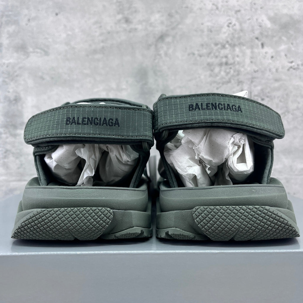 Balenciaga dark green sandals, heel view with BALENCIAGA logo and textured sole