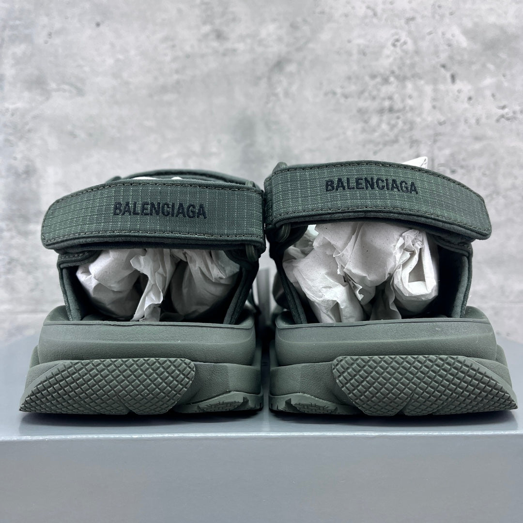 Balenciaga dark green sandals, heel view with BALENCIAGA logo and textured sole