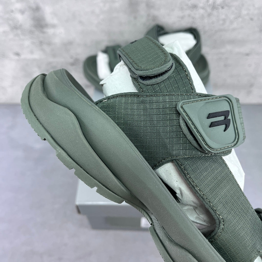Balenciaga dark green sandal, side view with adjustable strap and molded sole
