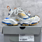 Balenciaga unisex sneakers on a shoebox: silver uppers with blue panels and gold accents.
