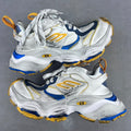 Balenciaga unisex sneakers in silver, blue, and gold with lace-up design and chunky sole.