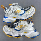 Balenciaga unisex sneakers in silver, blue, and gold with lace-up design and chunky sole.