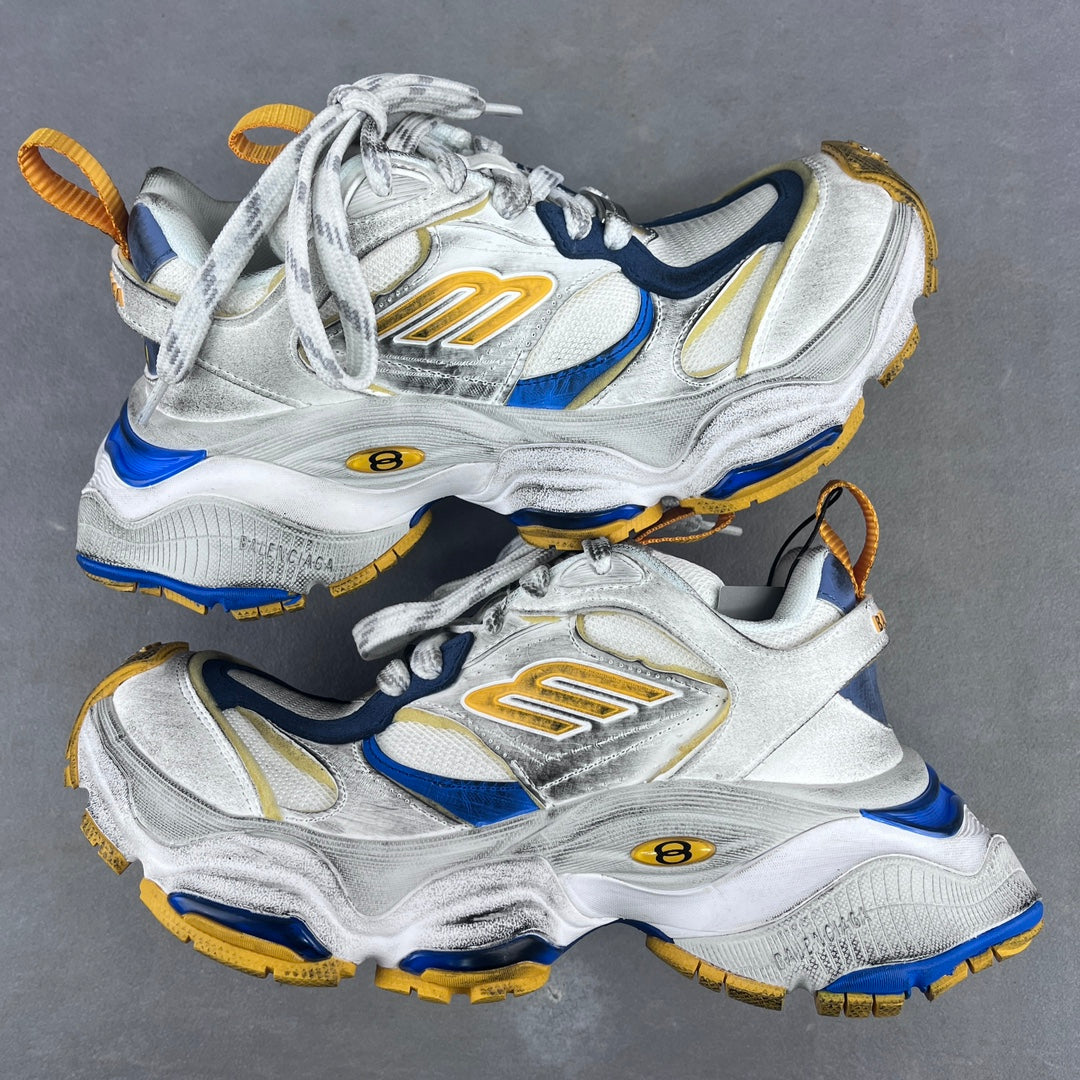 Balenciaga unisex sneakers in silver, blue, and gold with lace-up design and chunky sole.