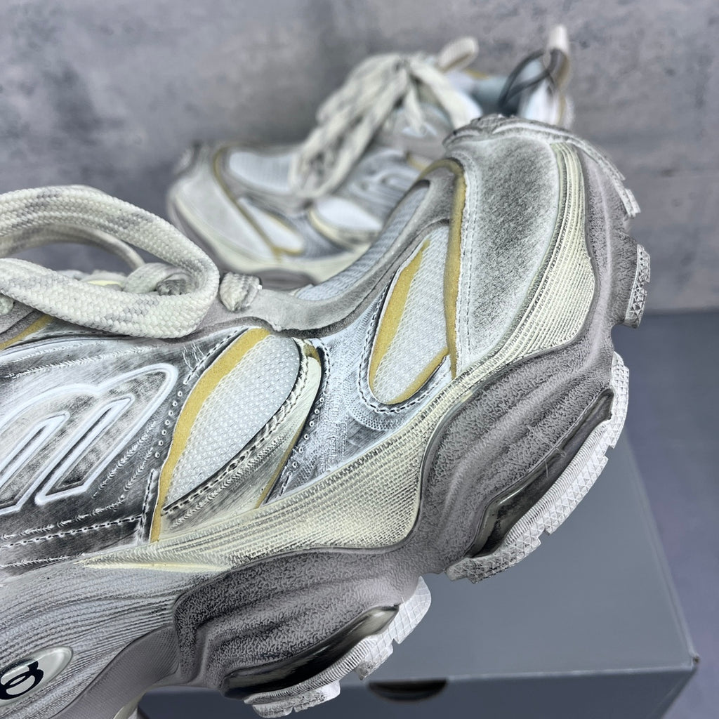 Balenciaga unisex sneaker with silver, white, and yellow trims, close-up side panel