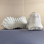 Dior unisex white sneakers, outsole view with rugged tread and heel pull tab