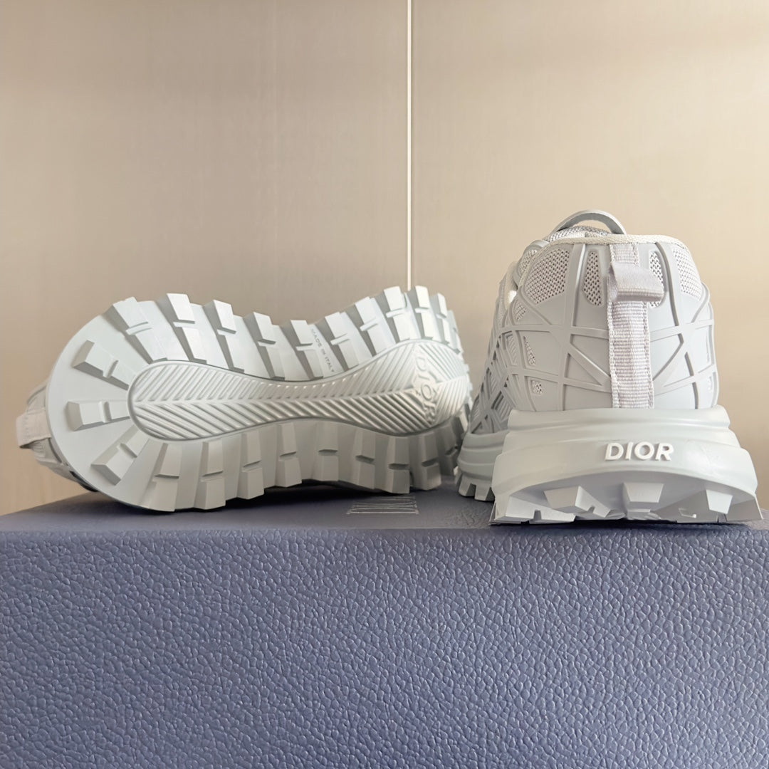 Dior unisex white sneakers, outsole view with rugged tread and heel pull tab
