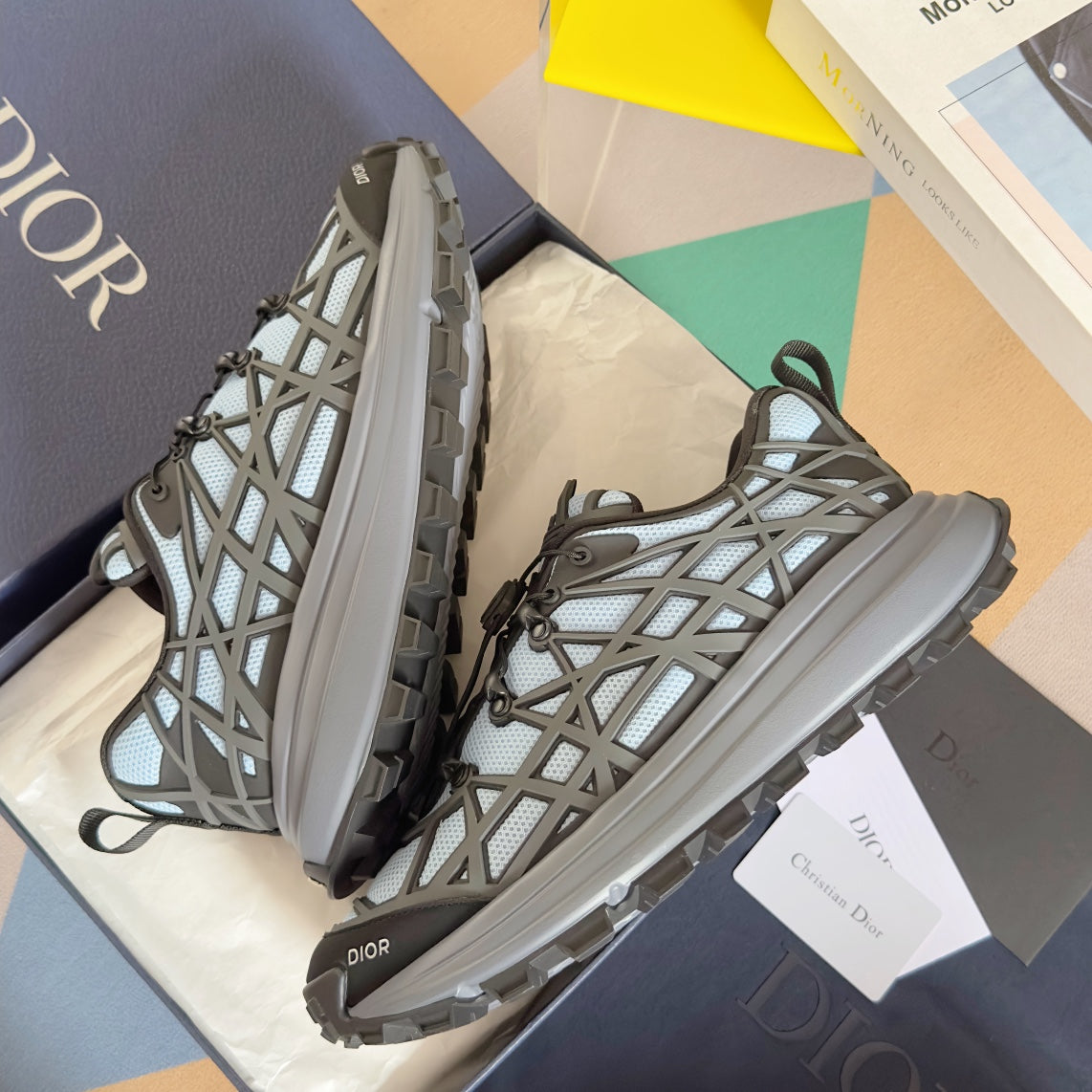 Unisex lace-up sneakers with light blue mesh and dark gray cross pattern, visible heel tread