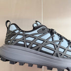 Unisex sneaker side profile: light blue mesh and dark gray lattice upper, thick tread sole