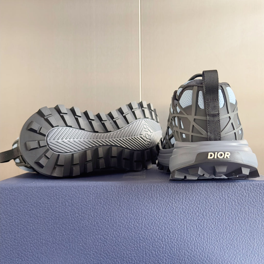 Unisex sneakers showing outsole; dark tread with light blue mesh upper and DIOR heel panel