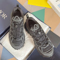 Dior unisex sneakers in dark gray with white lattice panels and chunky tread sole
