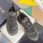 Dior unisex sneakers in dark gray with white lattice panels and chunky tread sole