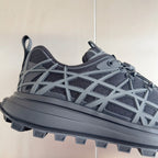 Dior unisex sneaker close-up, dark gray mesh and white lattice cage over thick sole