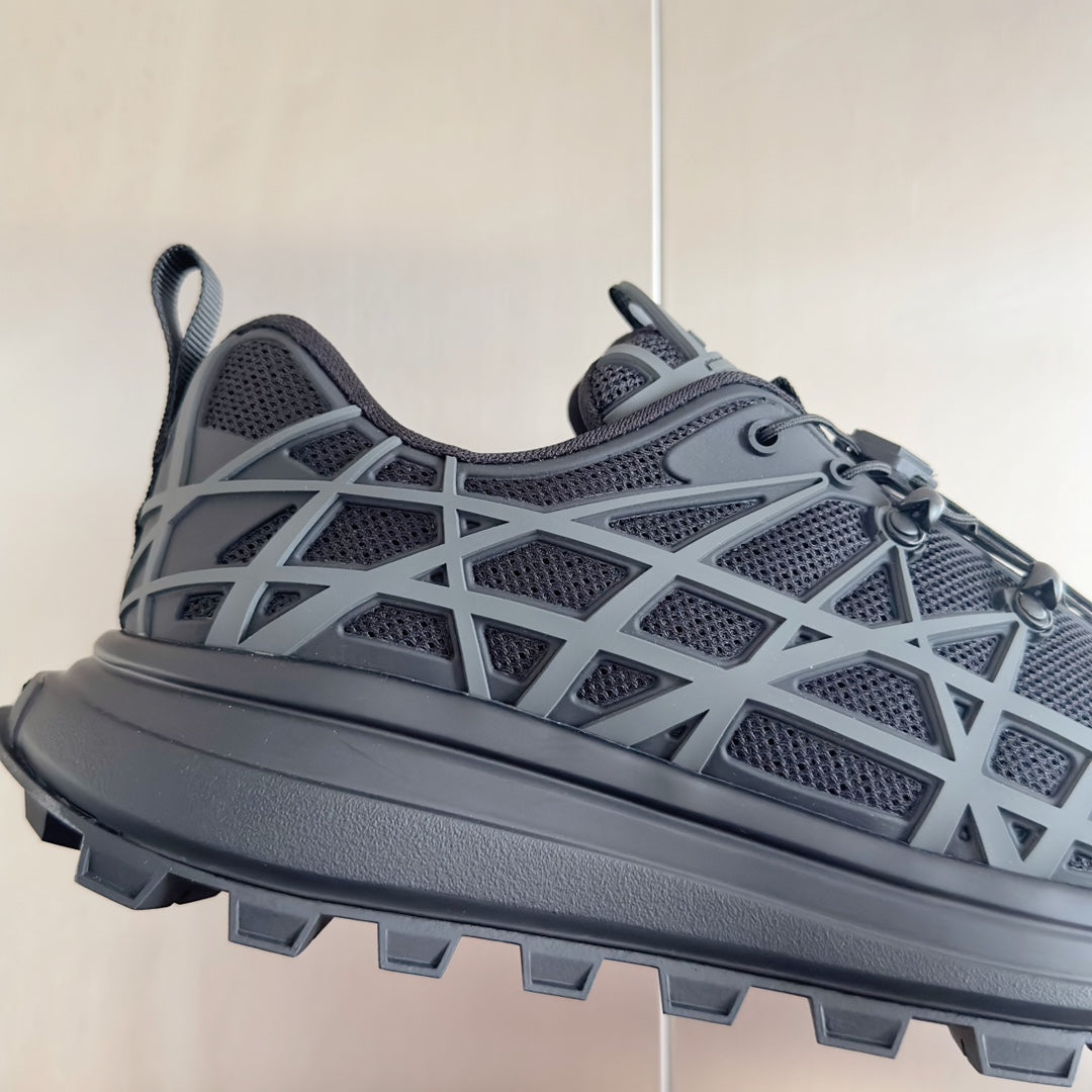Dior unisex sneaker close-up, dark gray mesh and white lattice cage over thick sole