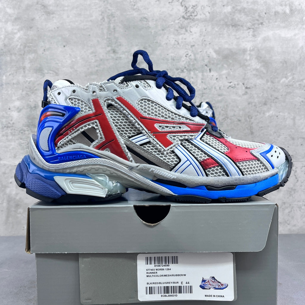 Color-block chunky sneakers: white mesh with red panels and blue laces.