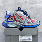 Color-block chunky sneakers: white mesh with red panels and blue laces.