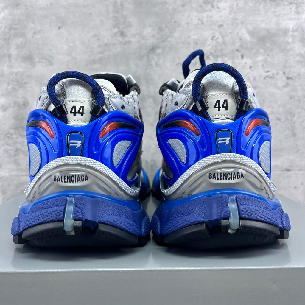 Back view of Balenciaga chunky sneakers with blue heel caps and white mesh uppers.