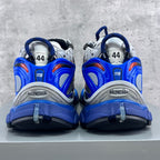 Back view of Balenciaga chunky sneakers with blue heel caps and white mesh uppers.