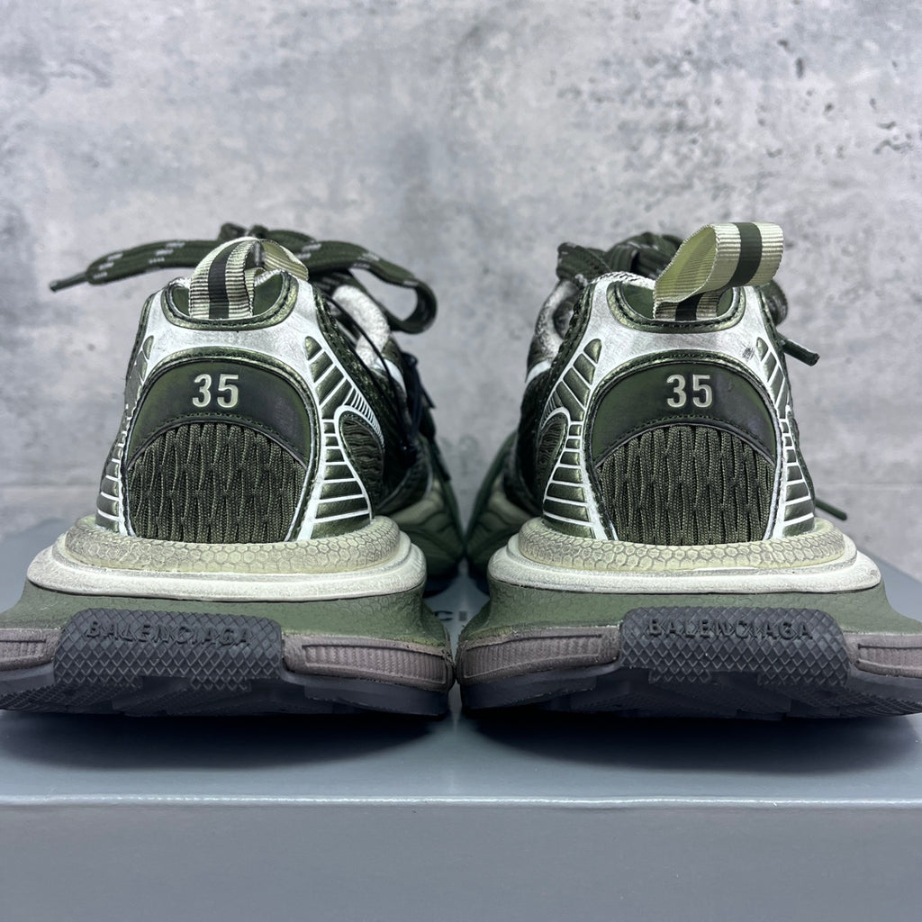 Heel view of sneakers with green and white uppers, “35” size marking on back