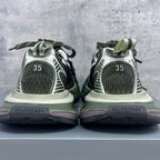 Heel view of sneakers with green and white uppers, “35” size marking on back