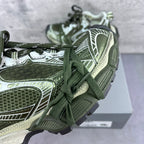 Close-up of lace-up sneakers: green laces with white, silver, and textured side panels