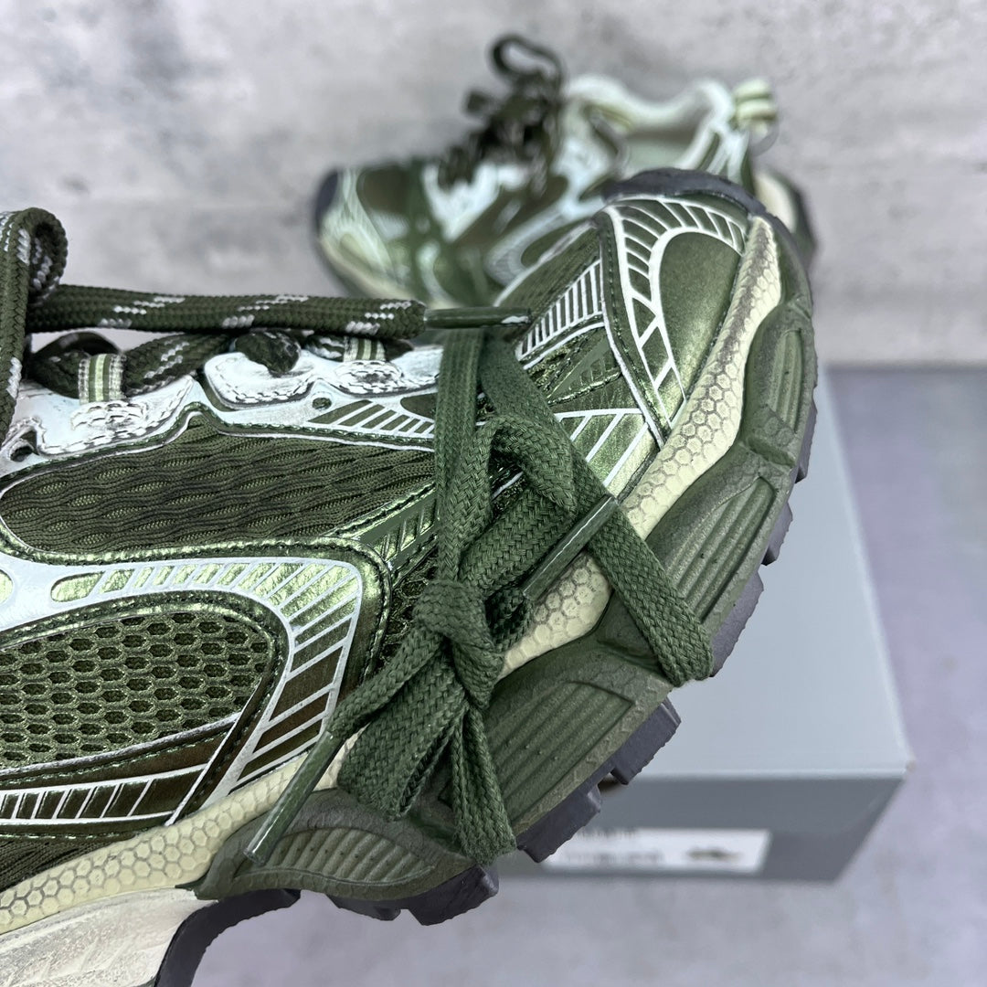 Close-up of lace-up sneakers: green laces with white, silver, and textured side panels