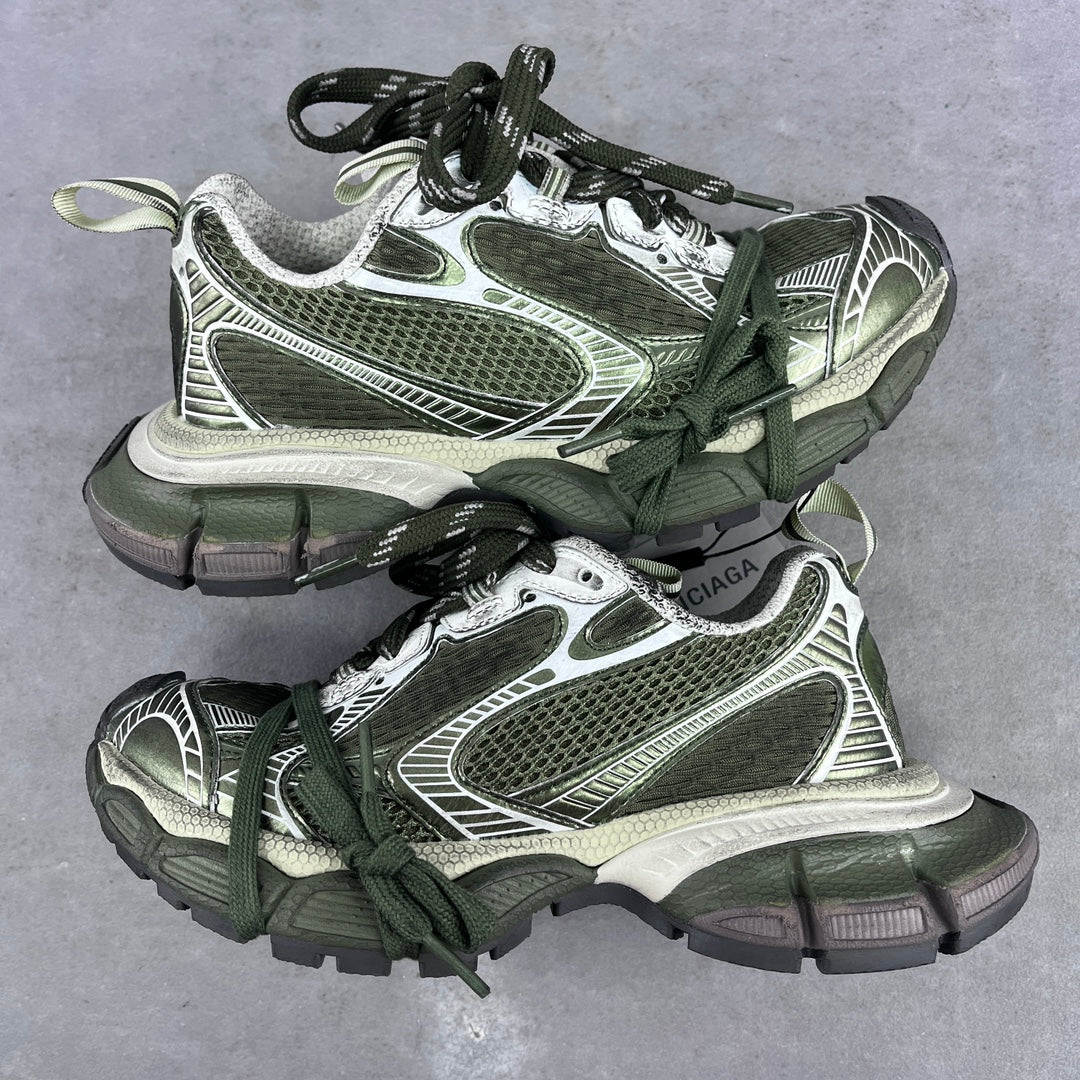 Chunky sneakers with green laces, white and silver panels, and textured mesh uppers